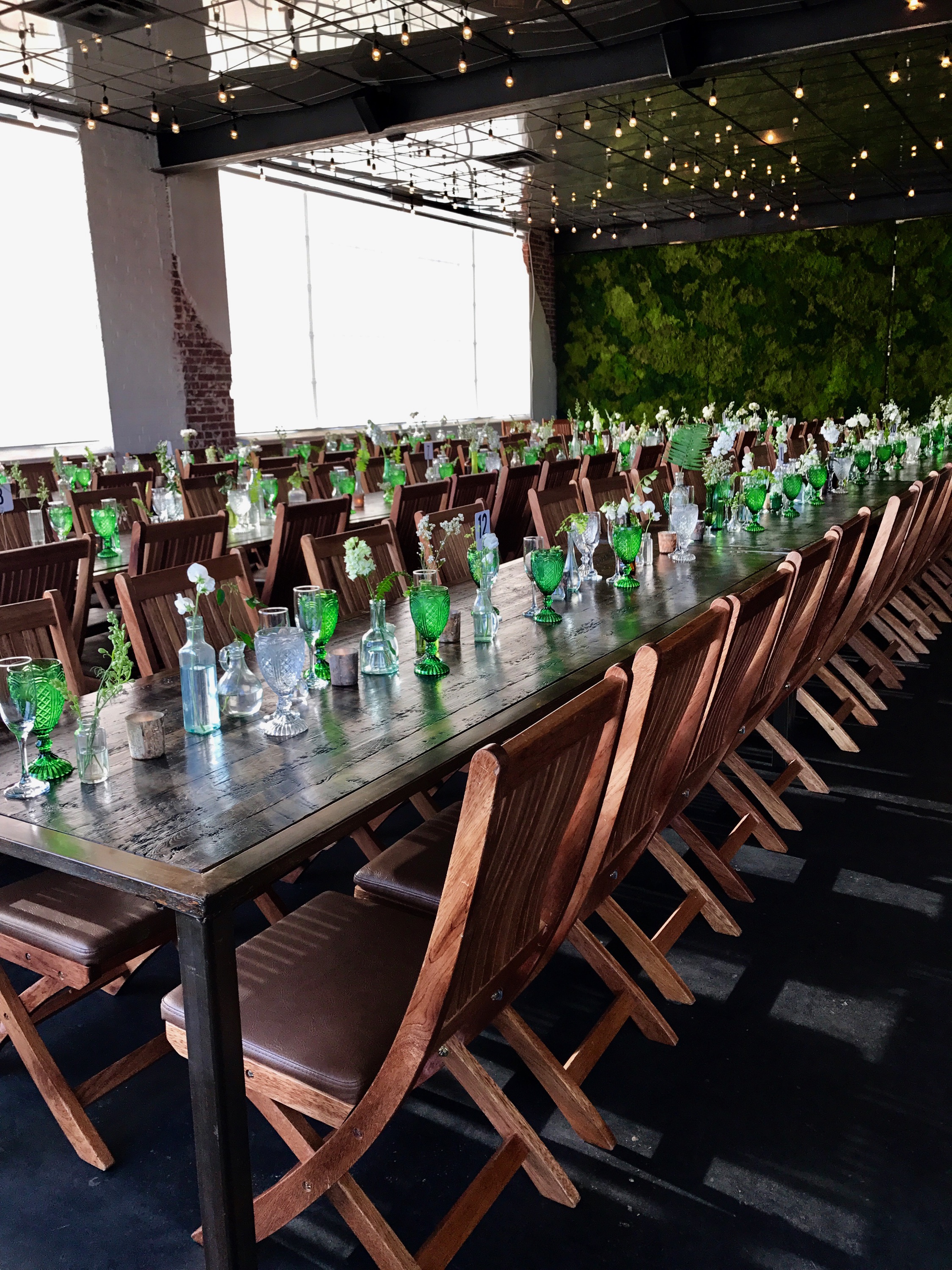 Moss green goblets feasting tables wedding reception