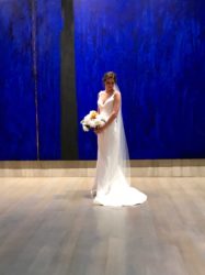 Bride and blue backdrop white bouquet