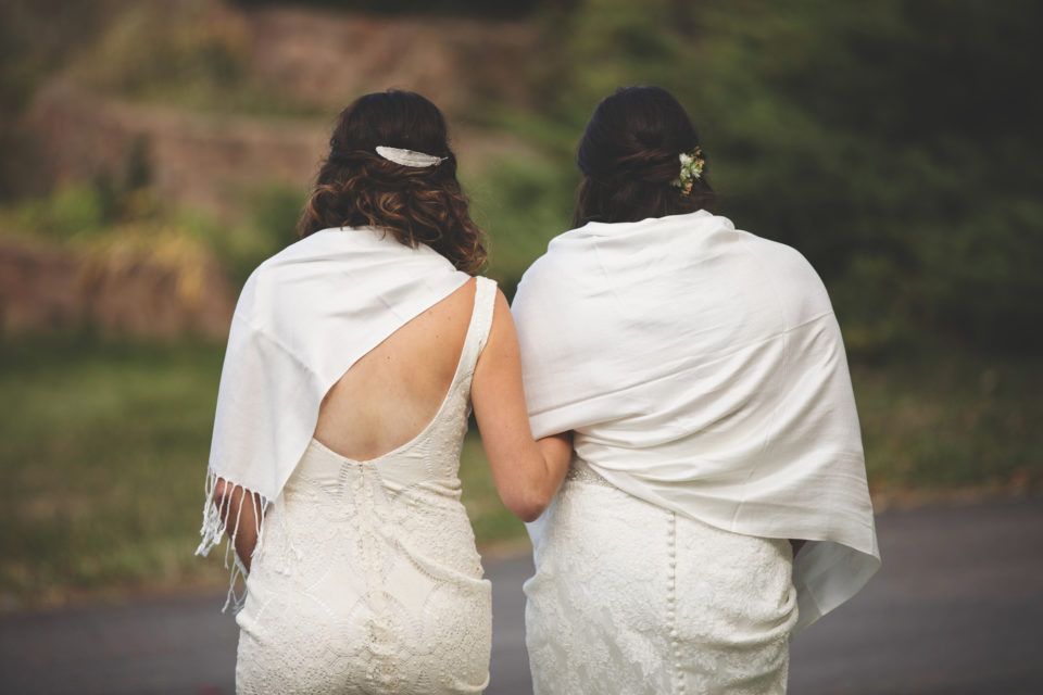 Brides holding arms shawls baretts
