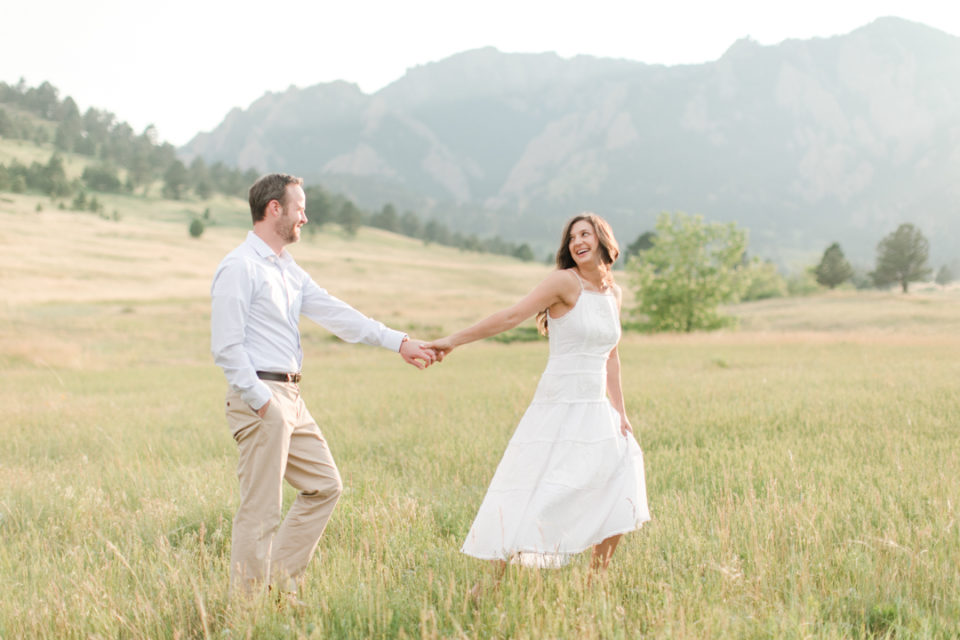 Flatirons couple Boulder Colorado holding hands