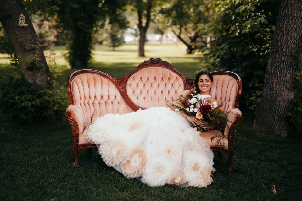 bride pink velvet couch portrait