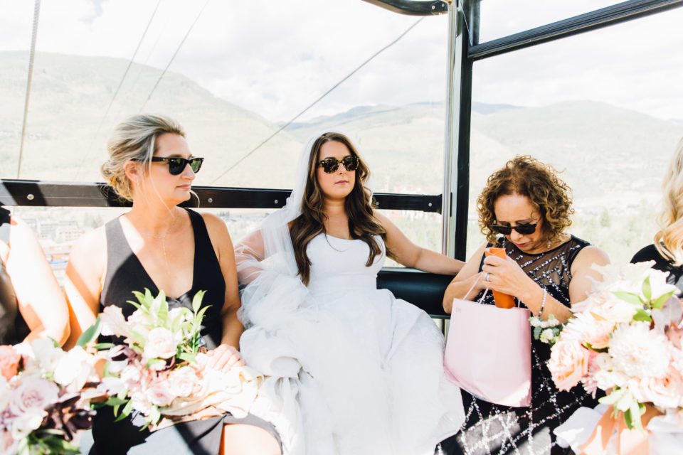 bride bridal party gondola ride to vail mountain deck